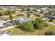 An elevated view showcases the rear pool deck and thick foliage at 2457 Tamworth Ter, Punta Gorda, FL 33983
