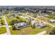 A sunny aerial view of a quiet neighborhood featuring neatly maintained homes and spacious green lawns at 2457 Tamworth Ter, Punta Gorda, FL 33983