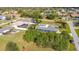 An aerial view of a blue home with an enclosed patio and mature landscaping in a sunny neighborhood at 2457 Tamworth Ter, Punta Gorda, FL 33983