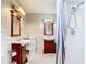 Well-lit bathroom featuring double sinks, tiled floors, and a shower with a shower curtain at 2457 Tamworth Ter, Punta Gorda, FL 33983