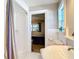 Bathroom featuring white tiled shower, toilet, and view to bedroom with wood floors at 2457 Tamworth Ter, Punta Gorda, FL 33983