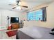 Bedroom with a ceiling fan, wood floors, and a window with lots of natural light at 2457 Tamworth Ter, Punta Gorda, FL 33983