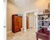 Spacious walk-in closet featuring a full-length mirror, ample storage, and tiled floors at 2457 Tamworth Ter, Punta Gorda, FL 33983