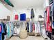 Bright walk-in closet with organized hanging racks, shelves, and a basket at 2457 Tamworth Ter, Punta Gorda, FL 33983
