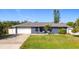 Charming single-story home with a well-manicured lawn and a two-car garage at 2457 Tamworth Ter, Punta Gorda, FL 33983