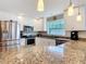 Modern kitchen featuring granite countertops, stainless appliances and white cabinetry at 2457 Tamworth Ter, Punta Gorda, FL 33983
