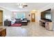 Living room with tile flooring, natural lighting, and stylish furniture, creating a welcoming space for relaxation at 2457 Tamworth Ter, Punta Gorda, FL 33983