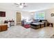 Comfortable living room featuring large windows and tile flooring, complemented by cozy seating and ample natural light at 2457 Tamworth Ter, Punta Gorda, FL 33983