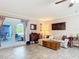 Open-concept living room with tile floors and French doors to patio, creating a relaxed and inviting space at 2457 Tamworth Ter, Punta Gorda, FL 33983
