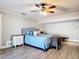 Tranquil main bedroom featuring wood floors, a ceiling fan and natural light at 2457 Tamworth Ter, Punta Gorda, FL 33983