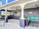 Outdoor kitchen and blue outdoor furniture on a covered patio with ceiling fans at 2457 Tamworth Ter, Punta Gorda, FL 33983