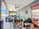 Covered patio with blue outdoor furniture, ceiling fans, nautical decor and an outdoor kitchen at 2457 Tamworth Ter, Punta Gorda, FL 33983