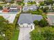 An aerial view of a two-story home with three-car garage in a residential neighborhood at 1731 Clearwater Harbor Dr, Largo, FL 33770
