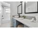 Bright bathroom featuring dual mirrors, stylish vessel sink, and elegant vanity with patterned backsplash at 1731 Clearwater Harbor Dr, Largo, FL 33770
