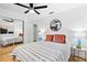 Cozy bedroom featuring a modern ceiling fan, mirrored closet, and chic decorative accents at 1731 Clearwater Harbor Dr, Largo, FL 33770