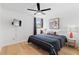 Cozy bedroom with a stylish bed, artwork, and hardwood floors at 1731 Clearwater Harbor Dr, Largo, FL 33770