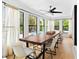 Bright dining room with a large wooden table, natural light, and views of the pool at 1731 Clearwater Harbor Dr, Largo, FL 33770