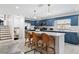Kitchen featuring stainless appliances, island seating and blue cabinets at 1731 Clearwater Harbor Dr, Largo, FL 33770