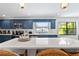 Bright kitchen features blue cabinets, stainless appliances, white countertop island, and recessed lighting at 1731 Clearwater Harbor Dr, Largo, FL 33770