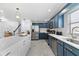 Updated kitchen with stainless steel appliances, white countertops, and blue cabinetry at 1731 Clearwater Harbor Dr, Largo, FL 33770