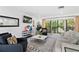 Living room featuring a large window, recessed lighting, and view into the backyard at 1731 Clearwater Harbor Dr, Largo, FL 33770