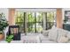 Cozy living room area with plush seating, a bay window, and view of the landscaped yard at 1731 Clearwater Harbor Dr, Largo, FL 33770