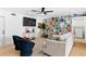 Inviting living room with modern ceiling fan, sleek furniture, and stylish decor at 1731 Clearwater Harbor Dr, Largo, FL 33770
