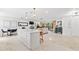 Open living room features white countertop island, tile flooring, and view into living room at 1731 Clearwater Harbor Dr, Largo, FL 33770