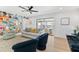 Light-filled living room featuring neutral decor, wood floors, and sliding glass doors to the outside at 1731 Clearwater Harbor Dr, Largo, FL 33770