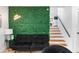 Modern interior featuring a green accent wall with a neon sign and a staircase leading to the upper level at 1731 Clearwater Harbor Dr, Largo, FL 33770