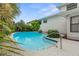 Inviting backyard pool with mature tropical landscaping surrounding the pool and patio area at 1731 Clearwater Harbor Dr, Largo, FL 33770