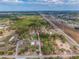 Aerial view of property, outbuildings, pond, and surrounding area with borders at 8279 Sunshine Grove Rd, Brooksville, FL 34613