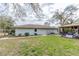 Exterior rear view of home showcasing open air covered patio area at 8279 Sunshine Grove Rd, Brooksville, FL 34613