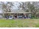 Large open air covered patio area showcasing furniture, tools and equipment at 8279 Sunshine Grove Rd, Brooksville, FL 34613