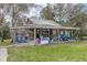 Large open air covered patio area showcasing furniture, tools and equipment at 8279 Sunshine Grove Rd, Brooksville, FL 34613