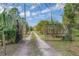 Gated entrance and long driveway leading to the property, offering privacy and seclusion at 8279 Sunshine Grove Rd, Brooksville, FL 34613