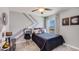 Modern bedroom with a unique wall design, comfortable bed, and a window with natural light at 30918 Silver Stage Dr, Brooksville, FL 34602