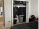 Open closet in bedroom with hanging clothes, shoe racks, and storage boxes at 18339 Turning Leaf Cir, Land O Lakes, FL 34638