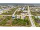 An aerial view provides a perspective of the property within its residential neighborhood and nearby water features at 8305 Welsford Rd, Port Charlotte, FL 33981