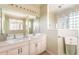 Bathroom with dual vanities, walk-in shower, soaking tub, and neutral color palette at 8305 Welsford Rd, Port Charlotte, FL 33981