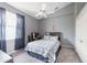 A well-lit bedroom with carpet flooring, a ceiling fan, and a window with sheer curtains at 8305 Welsford Rd, Port Charlotte, FL 33981