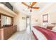 Main bedroom featuring tray ceiling, neutral colors, and a large dresser at 8305 Welsford Rd, Port Charlotte, FL 33981