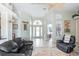 Bright foyer with tile flooring, an arched doorway, and a decorative light fixture at 8305 Welsford Rd, Port Charlotte, FL 33981