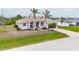 Inviting single-level house with a well-manicured lawn and a convenient two-car garage, creating a welcoming curb appeal at 8305 Welsford Rd, Port Charlotte, FL 33981