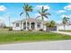 Inviting single Gathering home showcasing an arched entryway, garage and well-maintained lawn at 8305 Welsford Rd, Port Charlotte, FL 33981