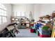 Spacious garage featuring workbenches, storage shelves, and various tools at 8305 Welsford Rd, Port Charlotte, FL 33981