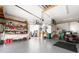 Spacious and tidy garage with ample storage shelves, lawn care equipment, and a clean floor at 8305 Welsford Rd, Port Charlotte, FL 33981