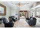 Comfortable living room with stylish ceiling fan and access to the screened patio at 8305 Welsford Rd, Port Charlotte, FL 33981