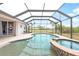 Inviting screened-in pool with attached spa and an expansive outdoor view at 8305 Welsford Rd, Port Charlotte, FL 33981
