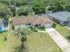 Aerial view of home with a large, lush backyard, surrounded by mature trees at 5078 Kenmore St, Spring Hill, FL 34608